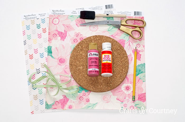 Scrapbook paper, cork circles, Mod Podge, craft paint, scissors, and a foam brush