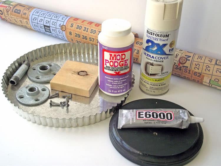 Wrapping paper, Mod Podge, Spray paint, tart pan, E-6000, wood plaque, and various parts