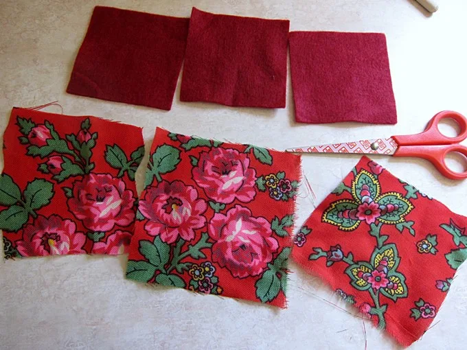 Cut out squares of fabric and felt using a pair of scissors