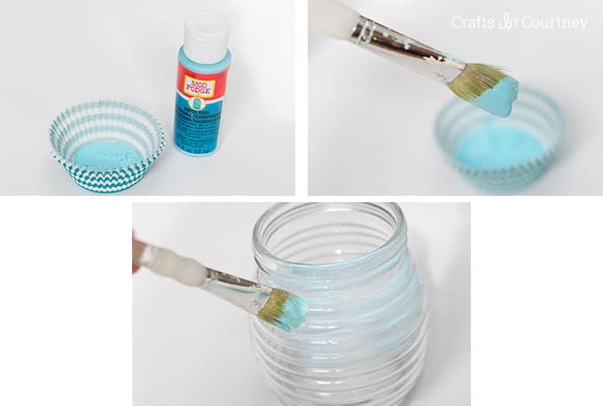 Painting colored Mod Podge onto a glass jar