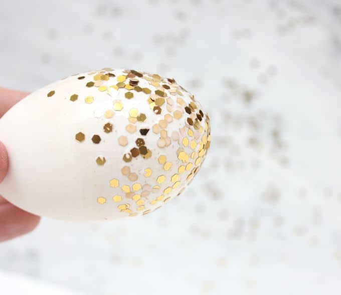 Cover plaster Easter eggs (or real ones!) with confetti and Mod Podge. This fun Easter craft is blingy and makes great decor!