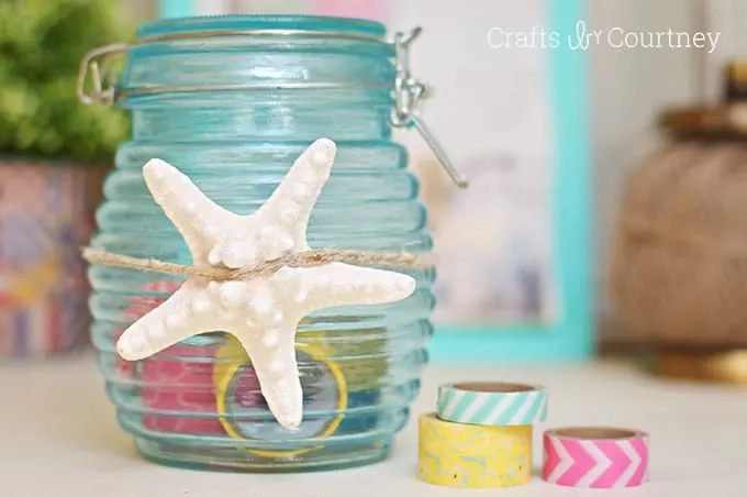Blue tinted glass jar with a starfish tied around the center