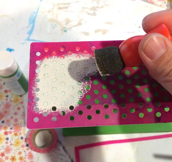 Using a spouncer to apply dots using paint and an adhesive stencil