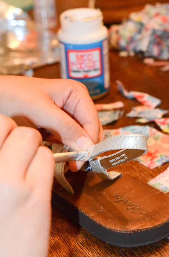 Painting a sandal strap with Mod Podge using a brush