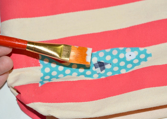 Attaching the fish details with a paintbrush and Mod Podge