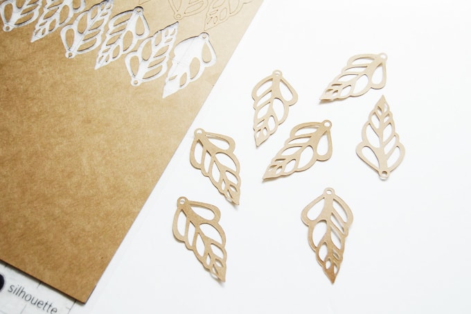 Cut paper seashell shapes from cardstock