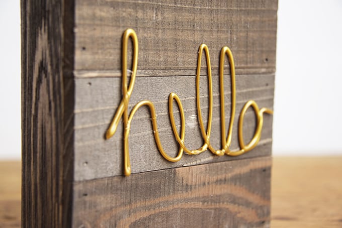 Gold hello glued to a wood pallet