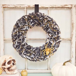 This Halloween wreath is so easy to make - it only takes about 30 minutes! Grab your cupcake liners, glitter, and Mod Podge. So festive!