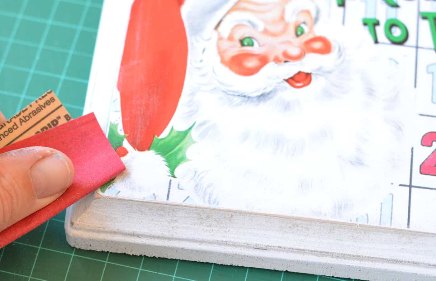 Sanding the edges of a DIY Christmas cake pop stand with sandpaper