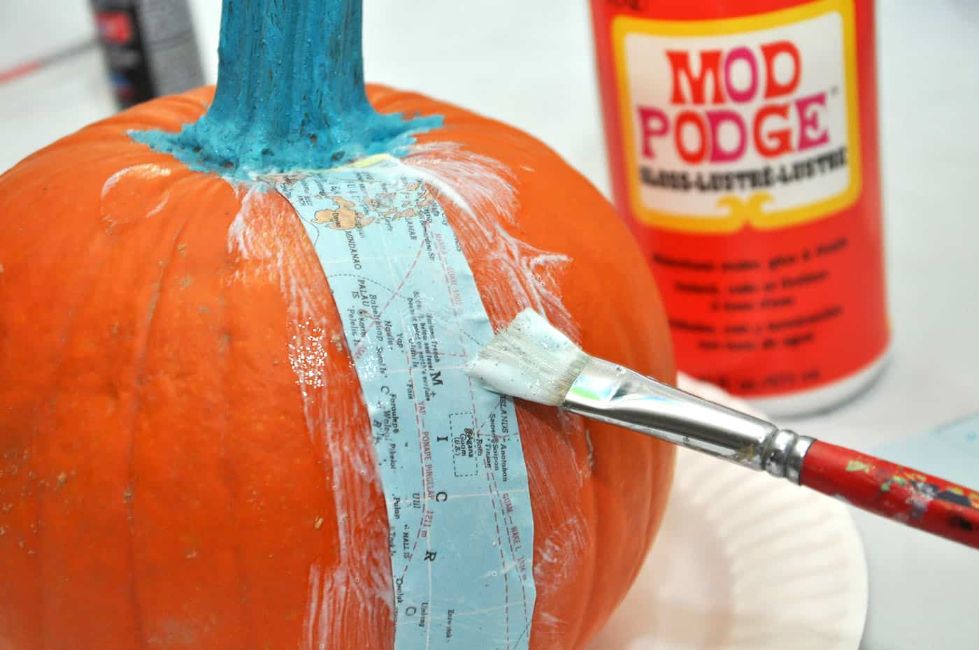 Applying a piece of map to a pumpkin
