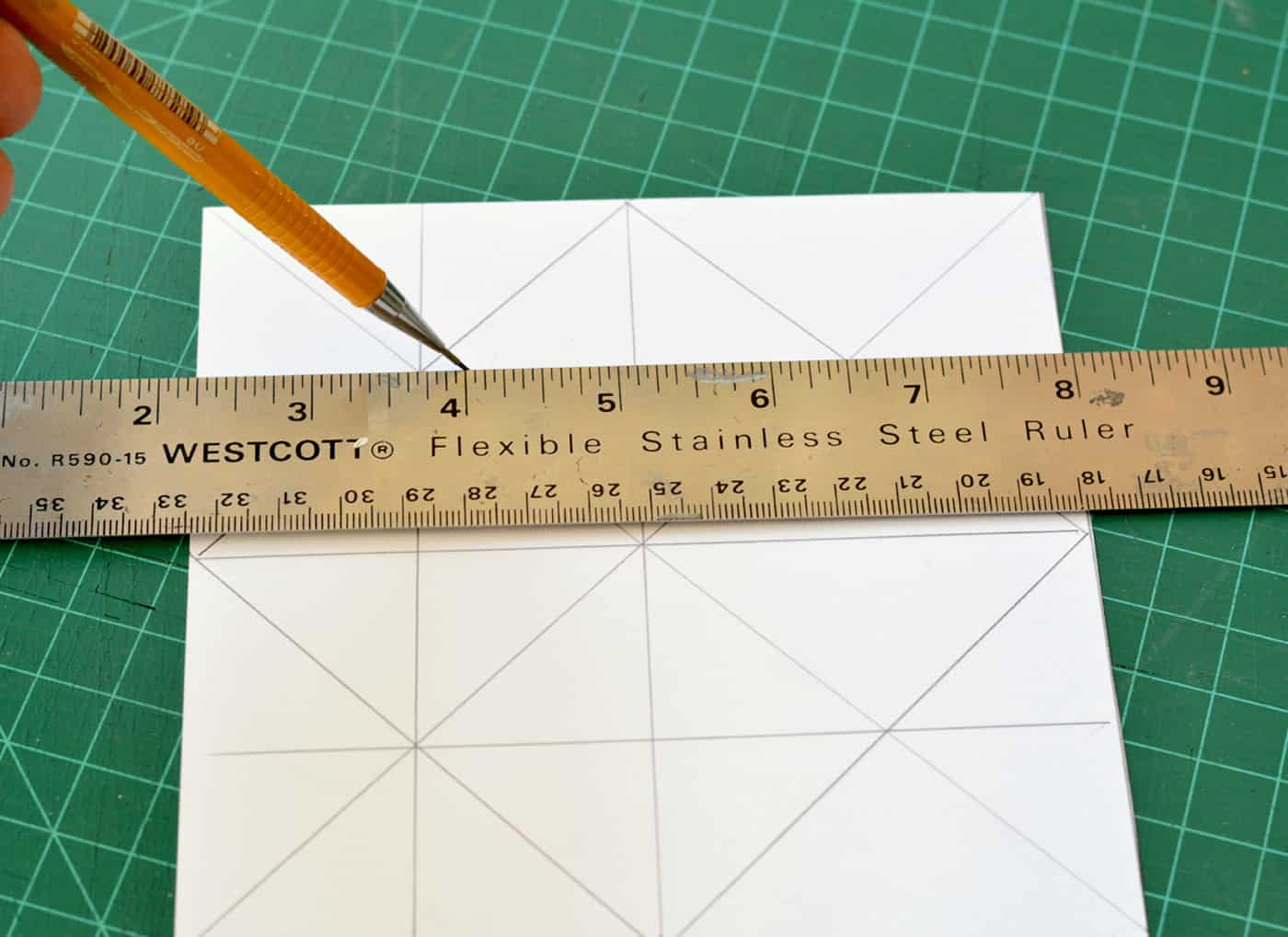 Making a grid on a piece of paper with a pencil and a steel ruler