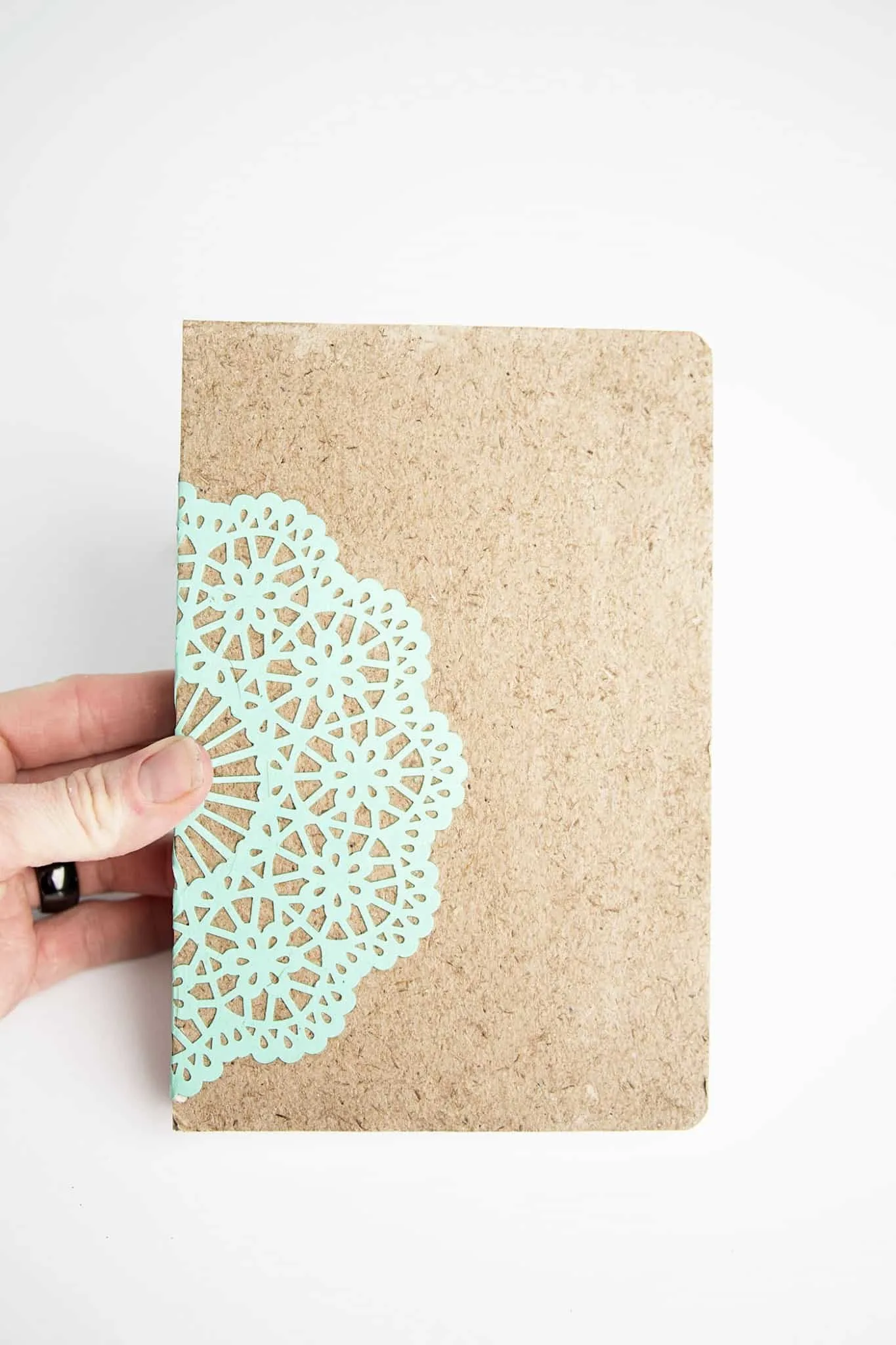 Paper doily dried to the front of a notebook