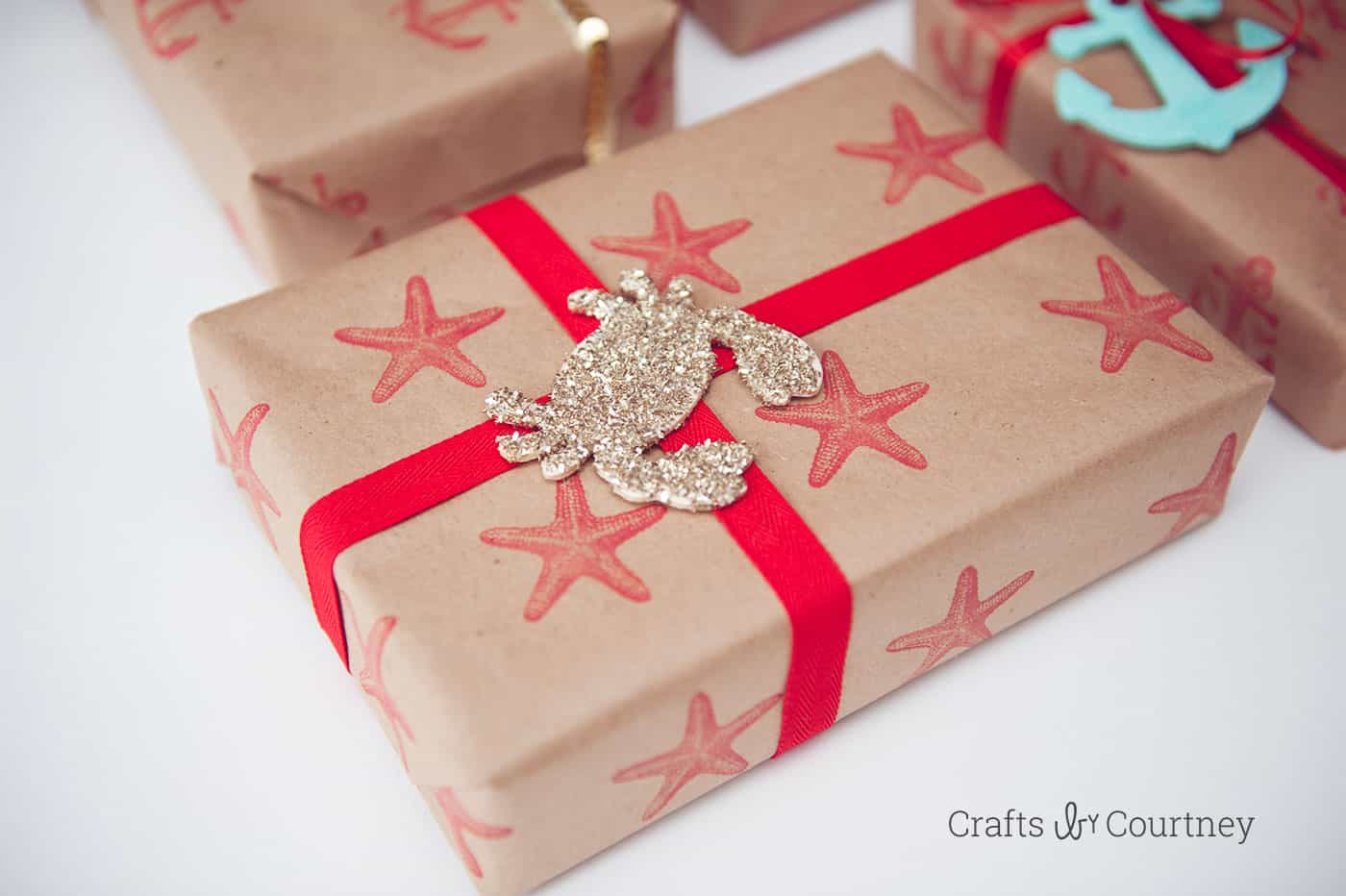 I fell in love with a beautiful nautical gift wrap from a magazine - so I decided to make my own DIY wrapping paper using stamps and glitter. So pretty!