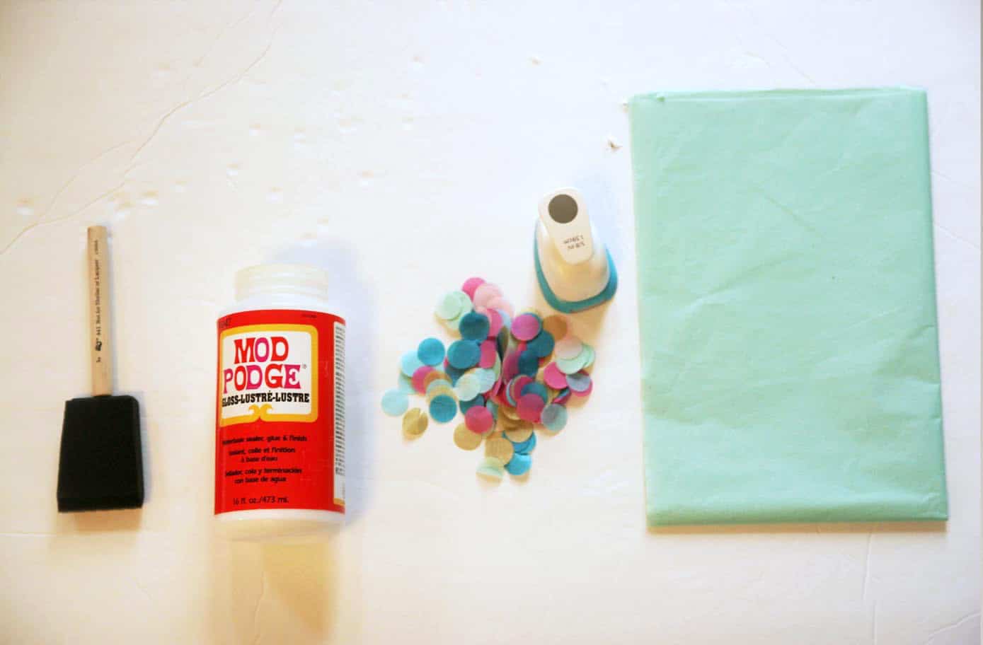 Foam brush, Mod Podge Gloss, confetti, circle punch, and tissue paper
