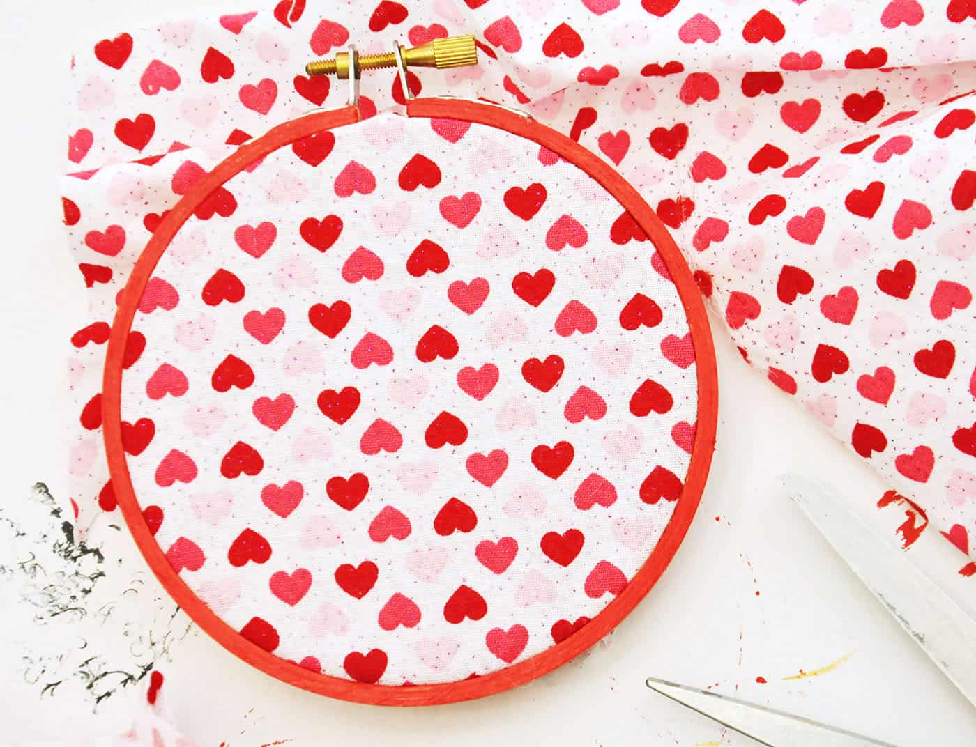 Valentine's Day heart fabric pulled through an embroidery hoop