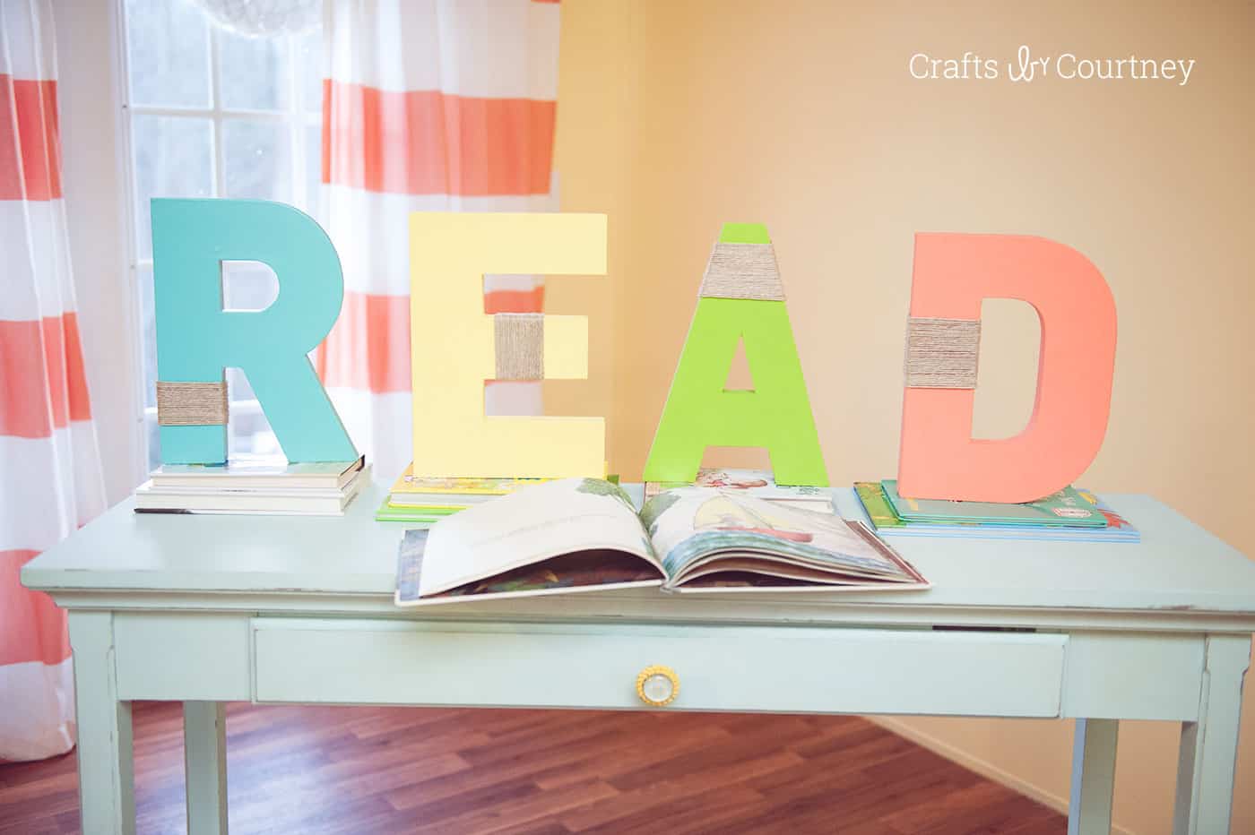 Decorating a book nook with wood letters spelling READ