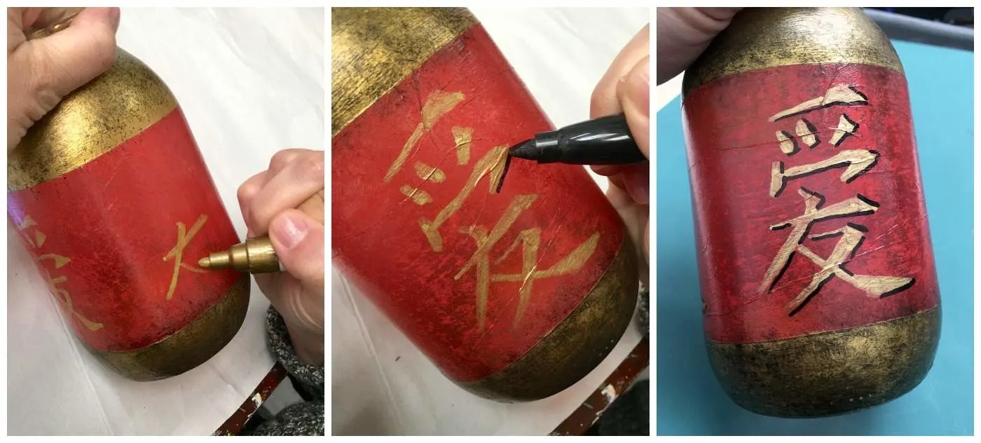 Using a paint pen to draw Chinese characters with gold paint and then adding black outlines in Sharpie