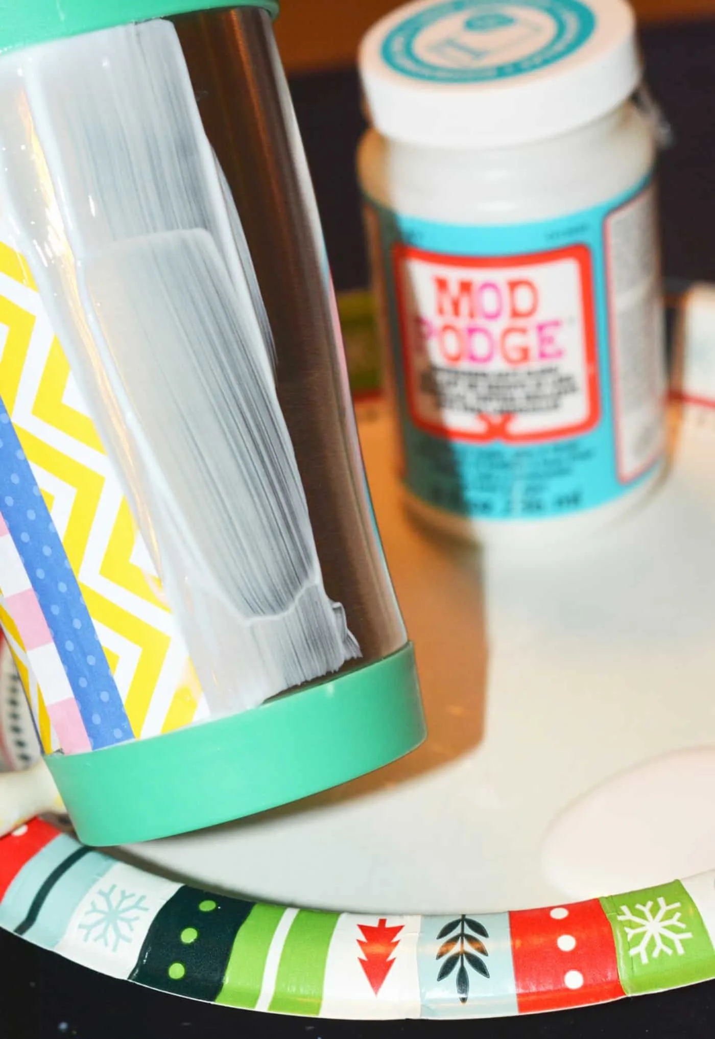 Placing paper on top of the Mod Podge on the side of the mug