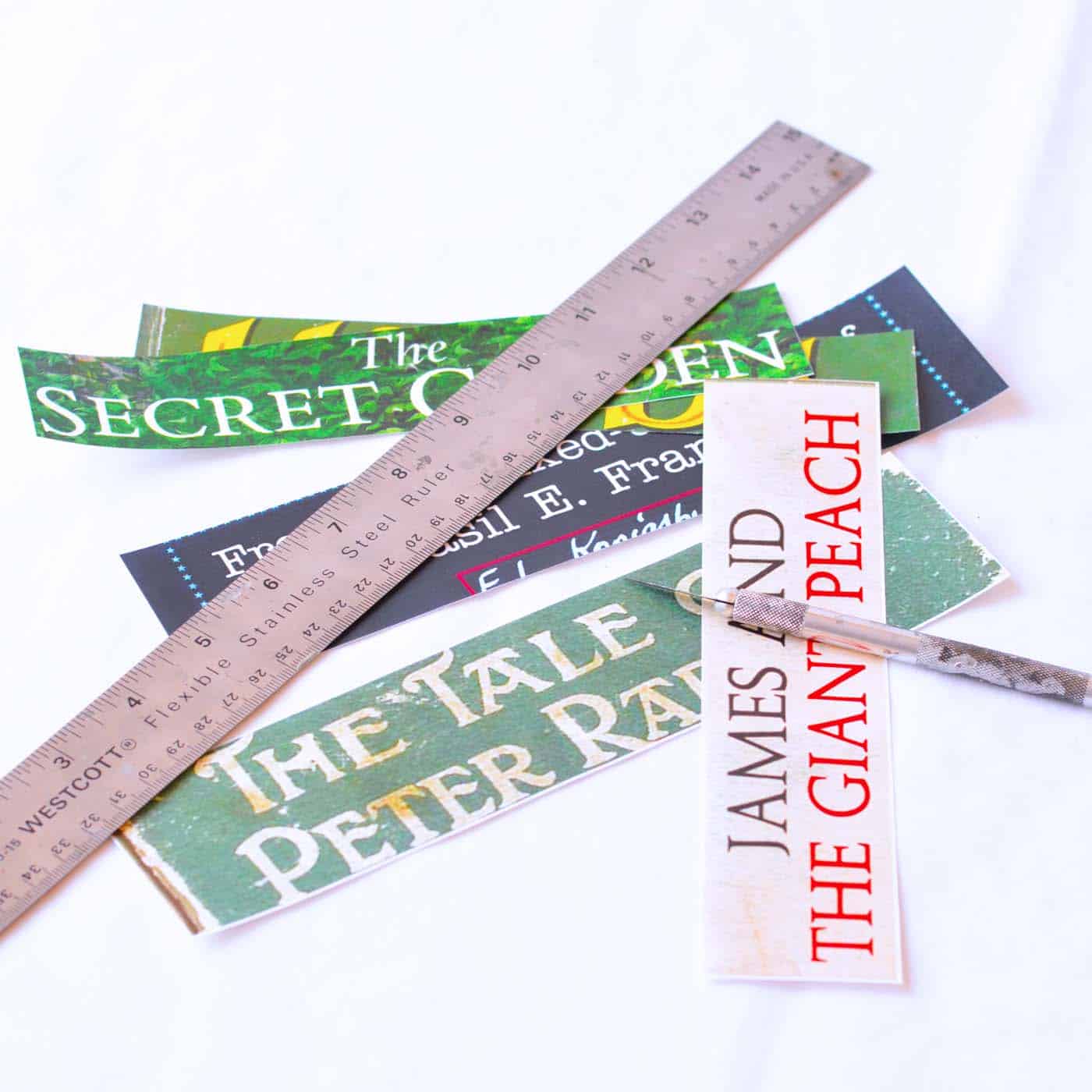 Cut out images of book titles along with a ruler and craft knife