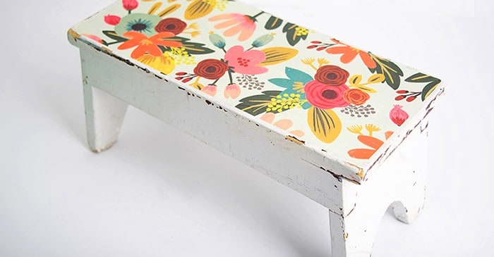 In this DIY stool makeover project, I revamped an antique store find with pretty paper and Mod Podge. It's really easy to do and the results are beautiful!