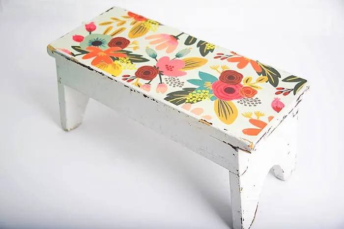 Decorate a wood step stool with paper and Mod Podge