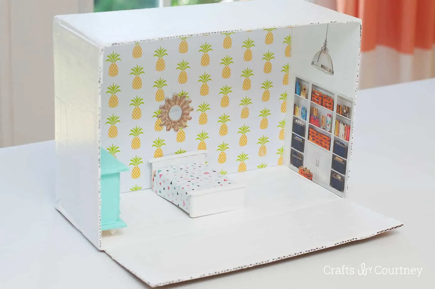 Don't spend big bucks on a dollhouse - this DIY dollhouse project will show you how to make an awesome version from a cardboard box!