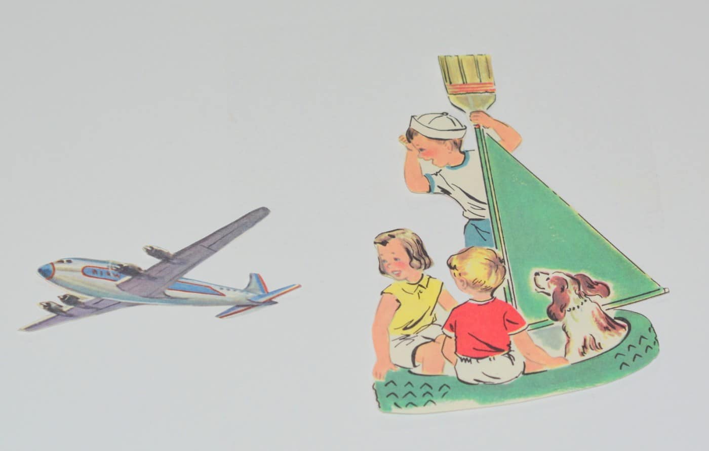 Shapes of a plane and children in a boat cut out