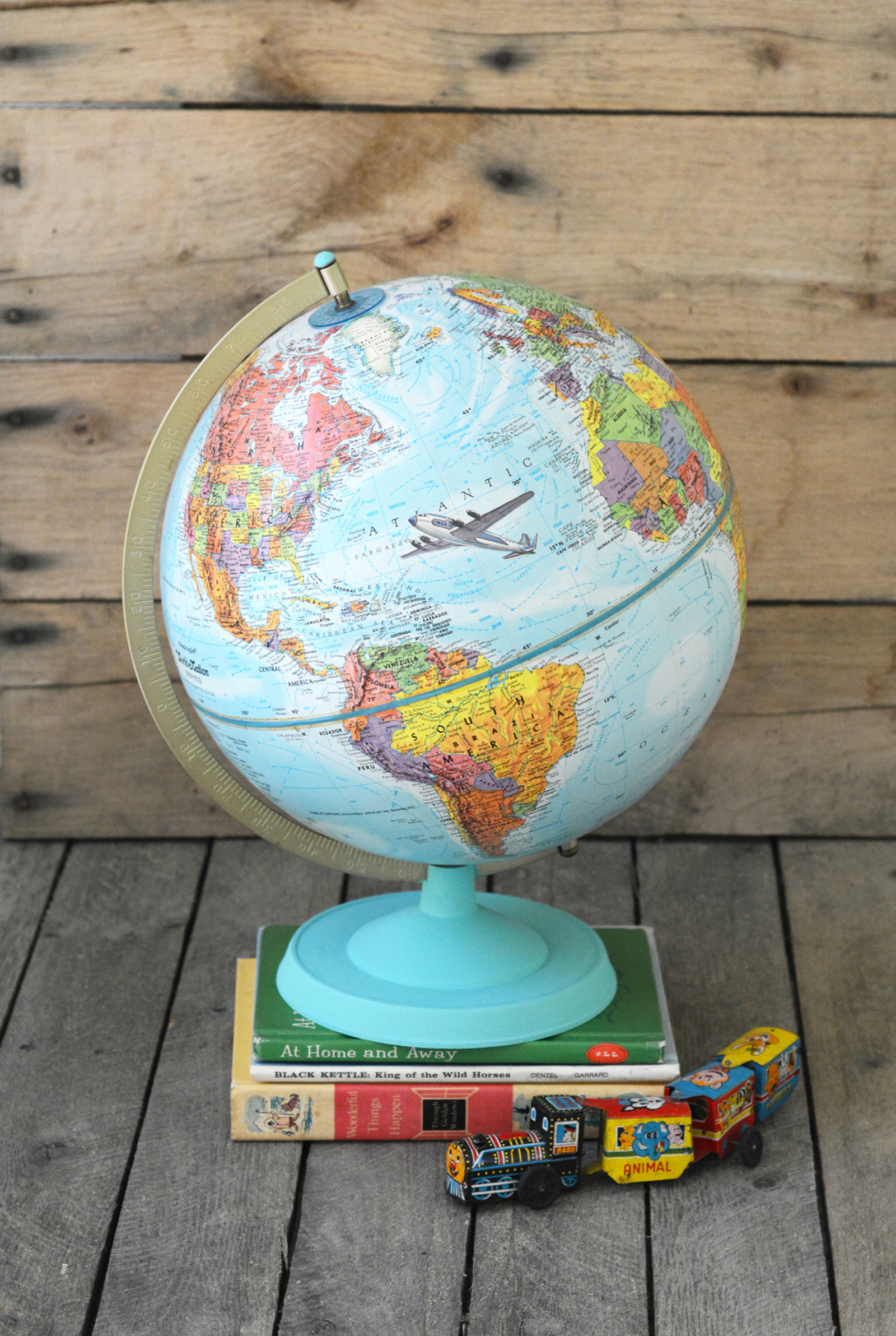 Learn how to customize a vintage globe with your favorite images from children's books - this is such a unique home decor project!