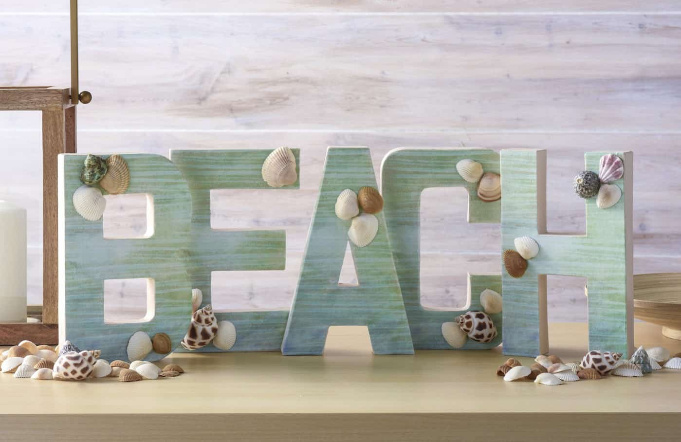 Make a fun project for summer! This DIY letter beach craft would look perfect on your mantel - and it's very easy to assemble with Mod Podge.