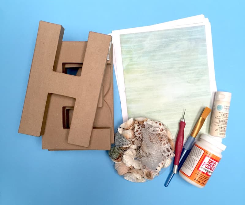 Paper mache letters, beach themed papers, acrylic paint, seashells, Mod Podge, paintbrush, craft knife