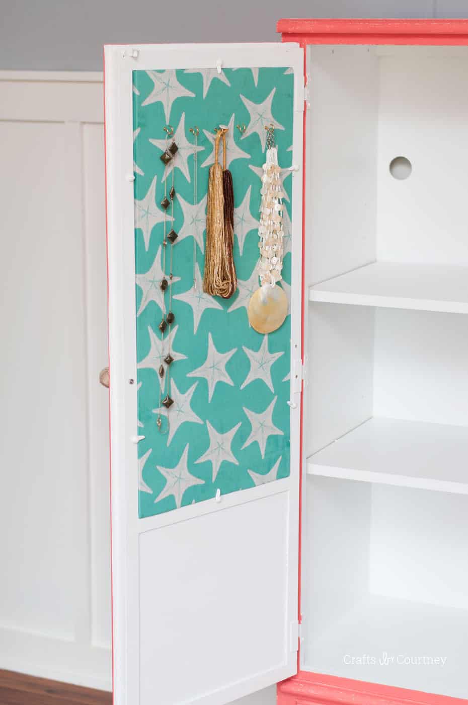 Courtney revamped her bathroom cabinet with pretty paint colors - and turned the inside into a cork board jewelry organizer with Mod Podge and fabric!