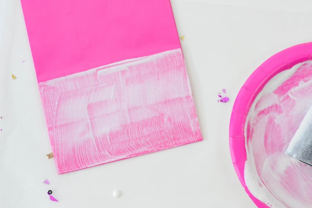 Line of Mod Podge painted across a pink favor bag