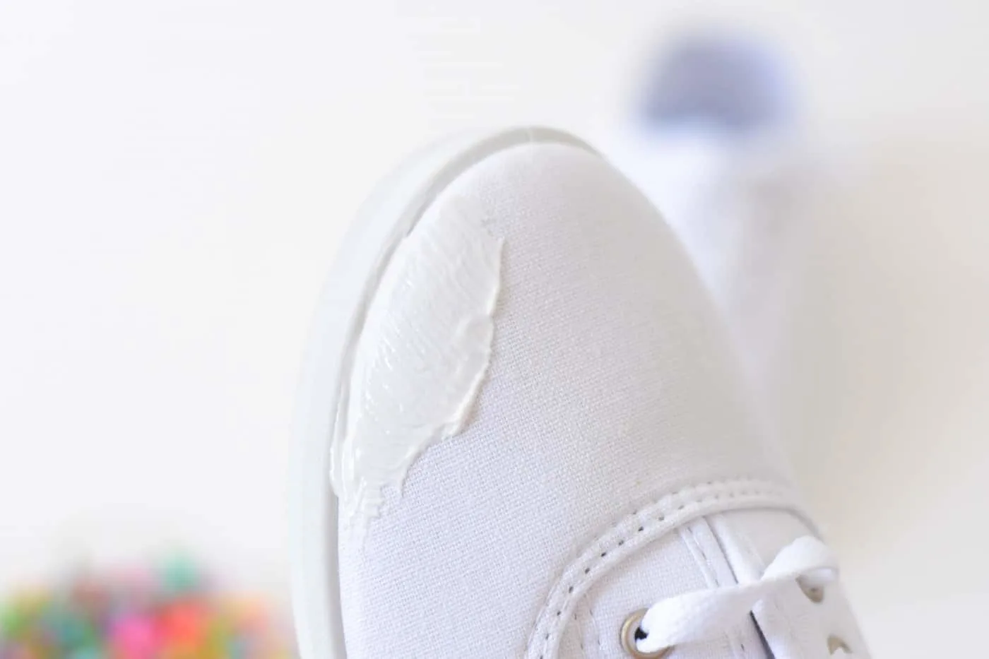 Mod Podge applied to the toe of a white shoe