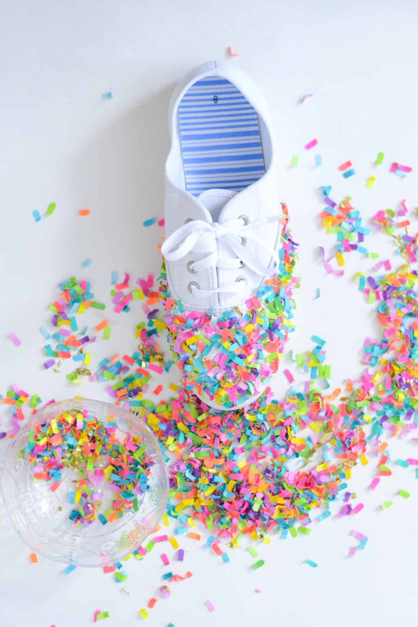 Colorful confetti pressed onto the toe of a white shoe