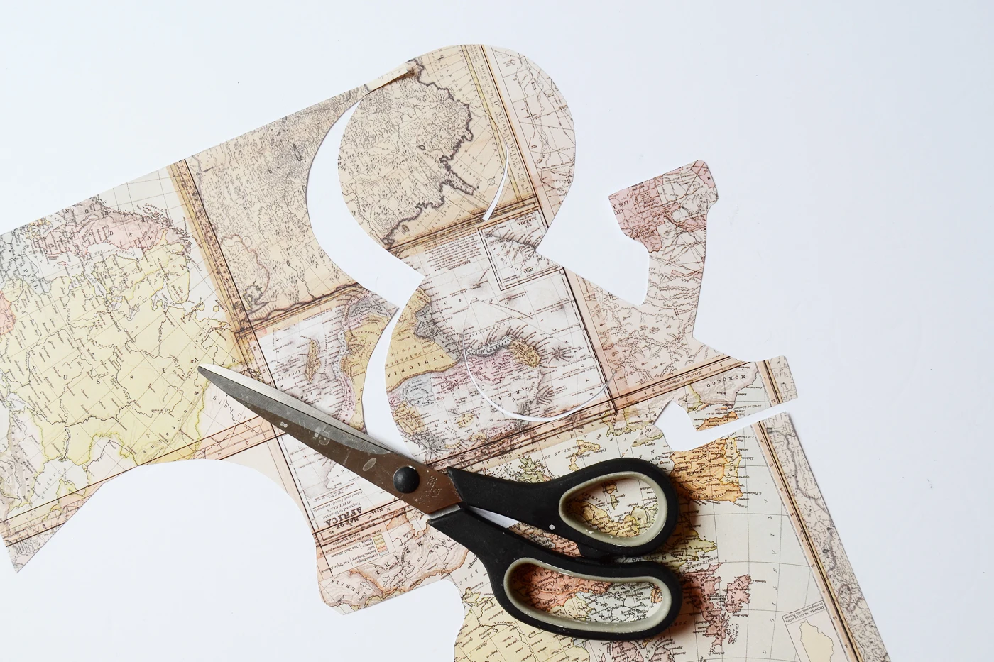 Cut out map paper with a pair of scissors