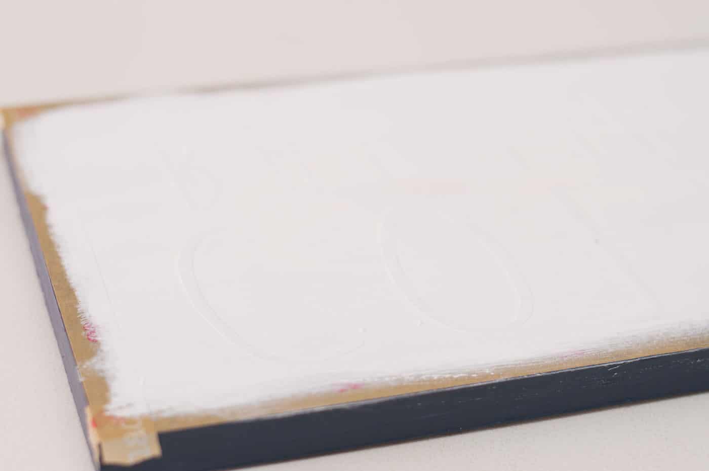 Paint white chalk paint on top of a wood sign project