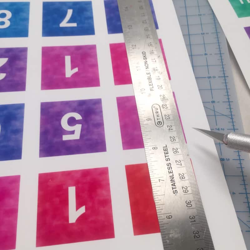 Trimming down the printable with a ruler and craft knife