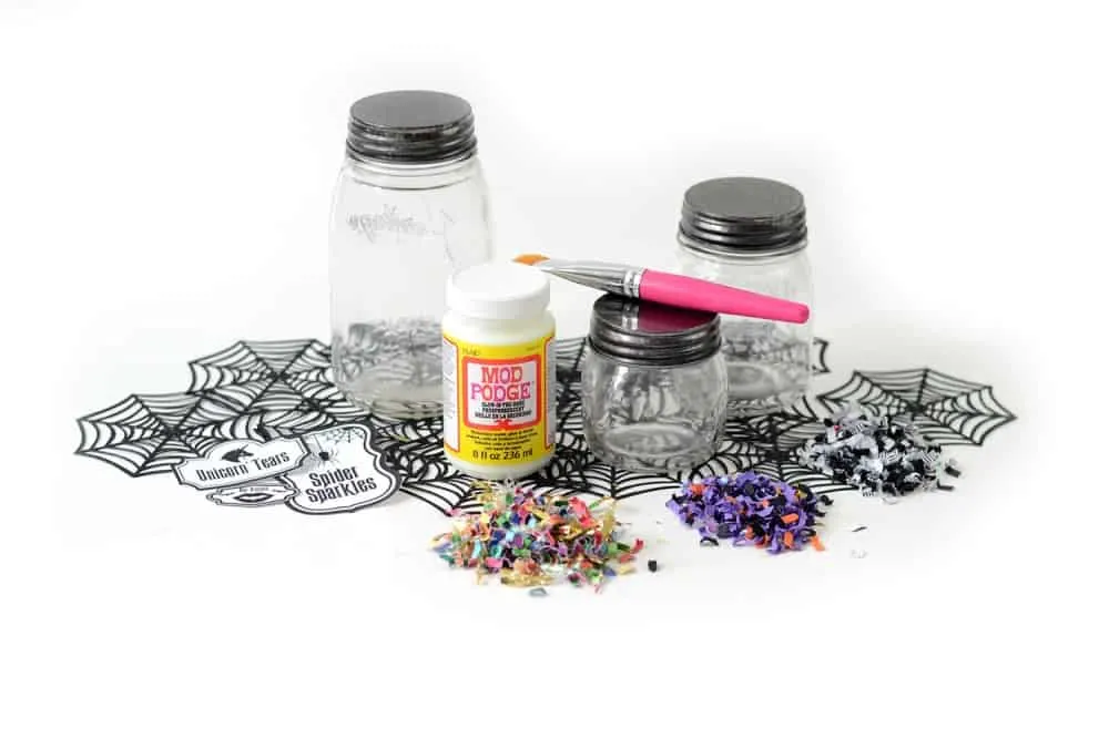 Clear jars with glow Mod Podge and Halloween confetti