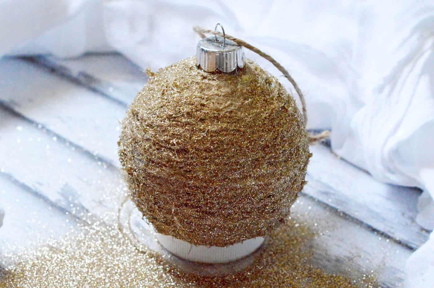 Glitter drying on the twine Christmas ornament