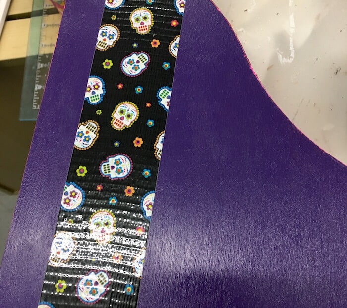 Adding sugar skull Duck Tape to the side of the magazine holder