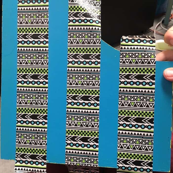 Three pieces of Duck Tape added to the side of a blue magazine holder