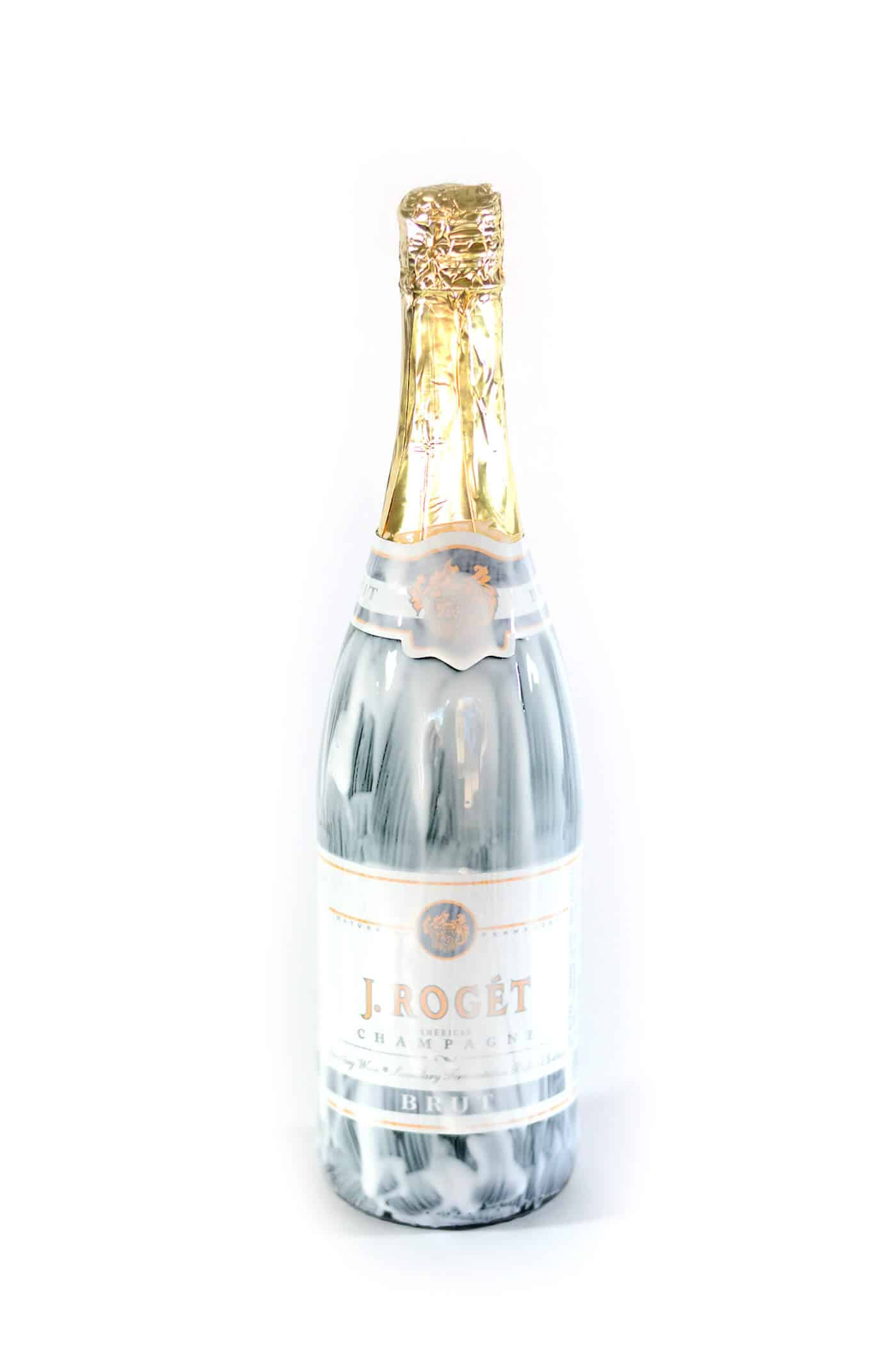 Champagne bottle covered in Mod Podge