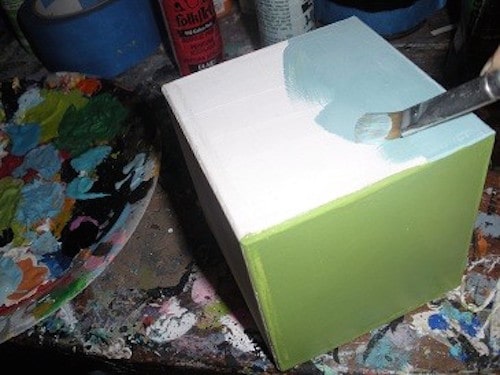 Painting blue on one side of the wood block