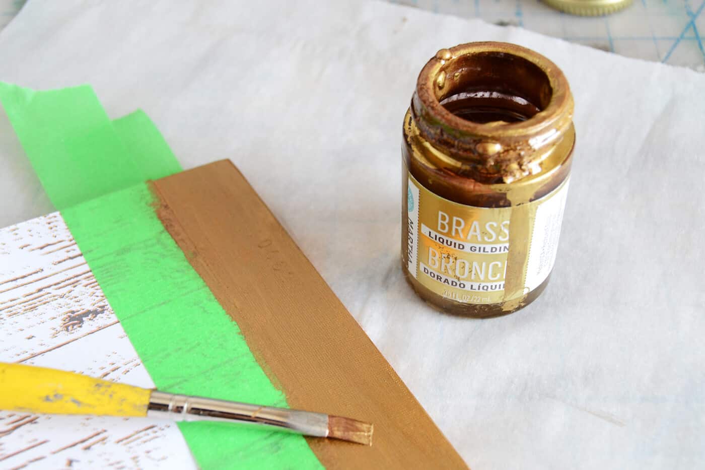 Painting the edge of the notebook cover with Martha Stewart Brass liquid gilding