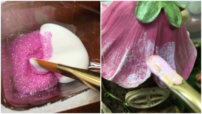 Painting pink glitter and Mod Podge on the roof of a fairy flower house