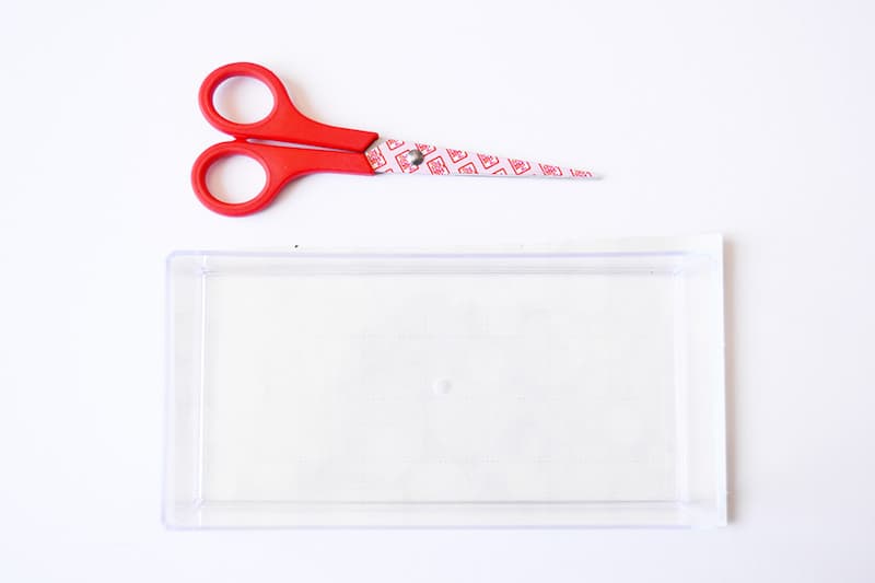 Acrylic tray and a pair of scissors