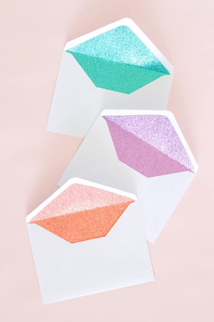 These DIY glitter lined envelopes are easy to make and add a surprise pop of color when the envelope is opened! Perfect for party invitations.