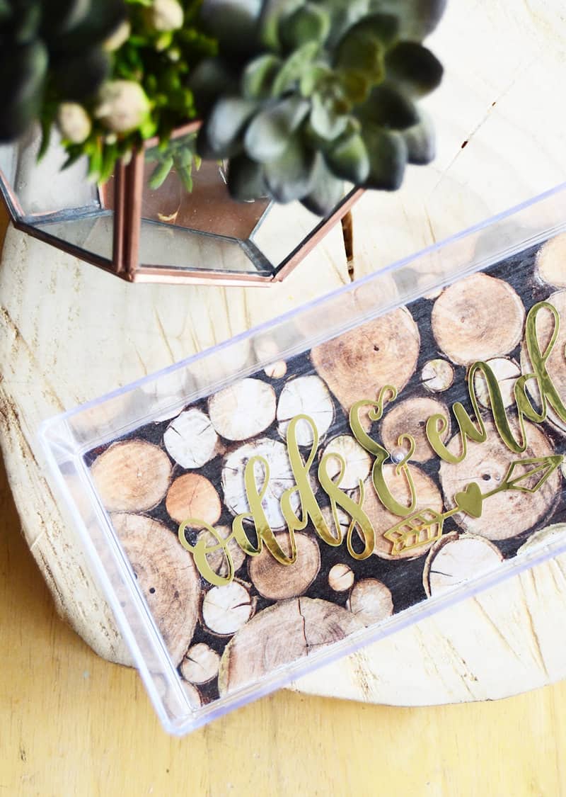 Clear acrylic tray decorated with paper that says odds and ends