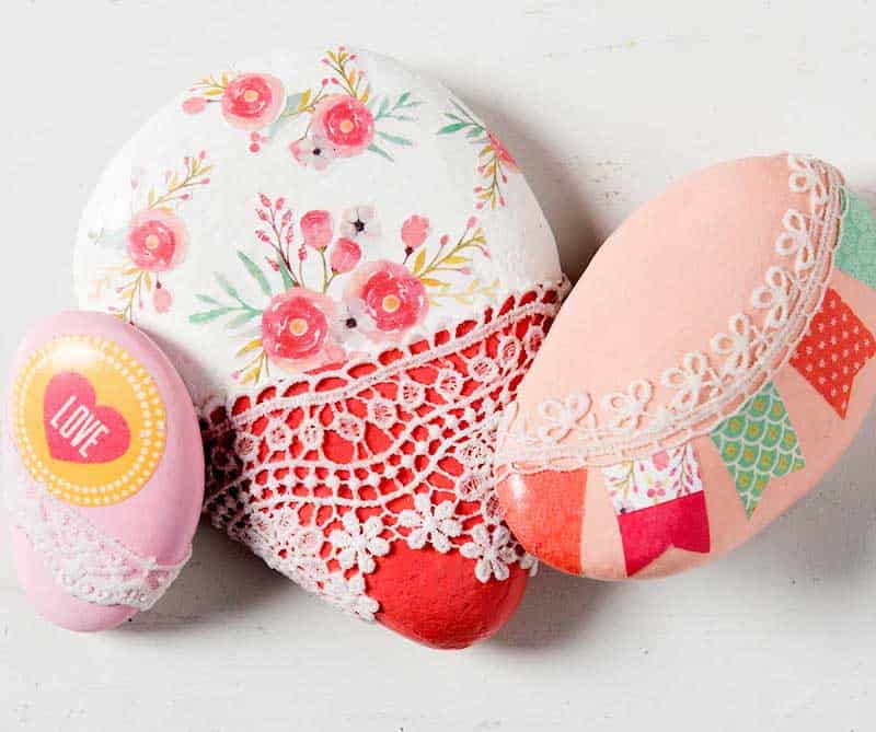 Rocks decorated with scrapbook paper and lace