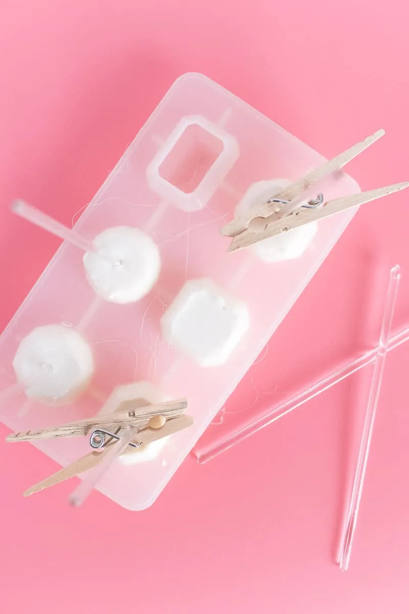 Hot glue in a silicone mold with plastic drink stirrers